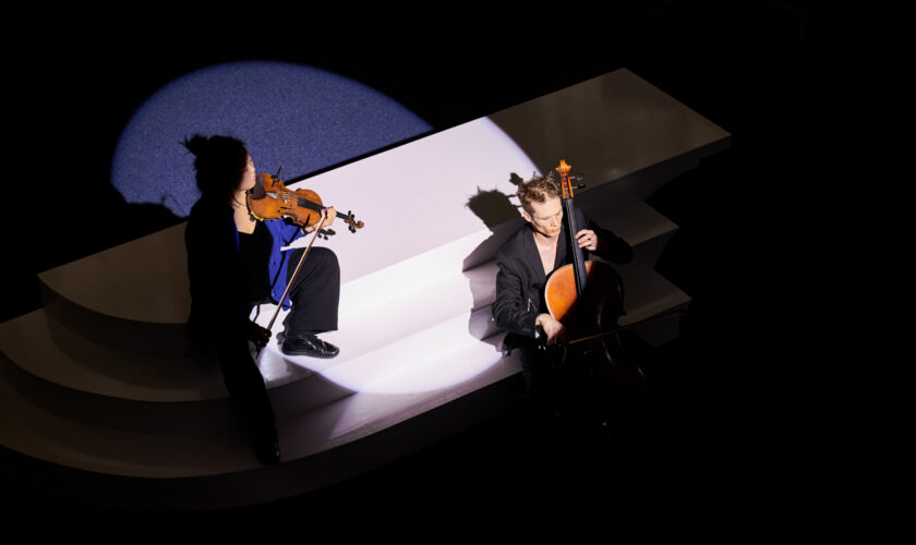 Sung Mi Marina Kim and Christopher Loy in the spotlight on interactive seasaw sculpture.