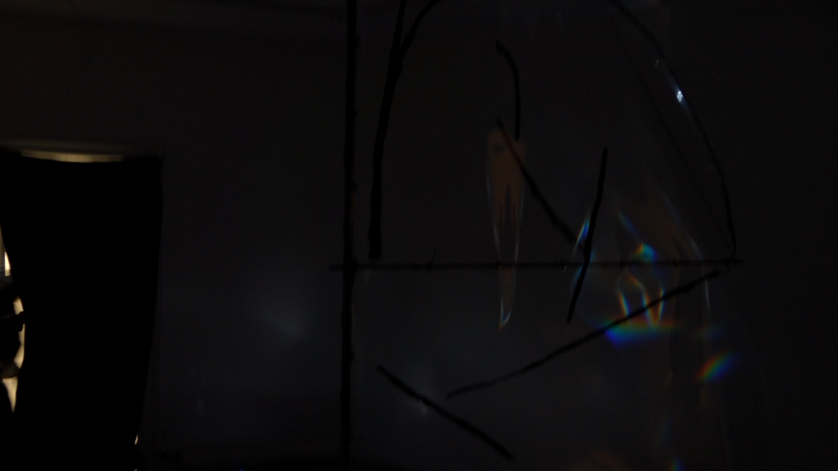 Detail view of refracted spectral light on a translucent foil sail.