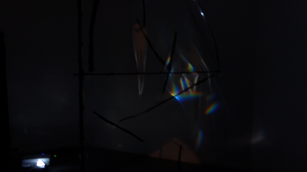 Detail view of refracted spectral light on a translucent foil sail.