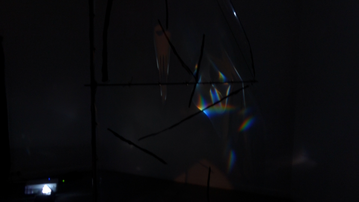 Detail view of refracted spectral light on a translucent foil sail.