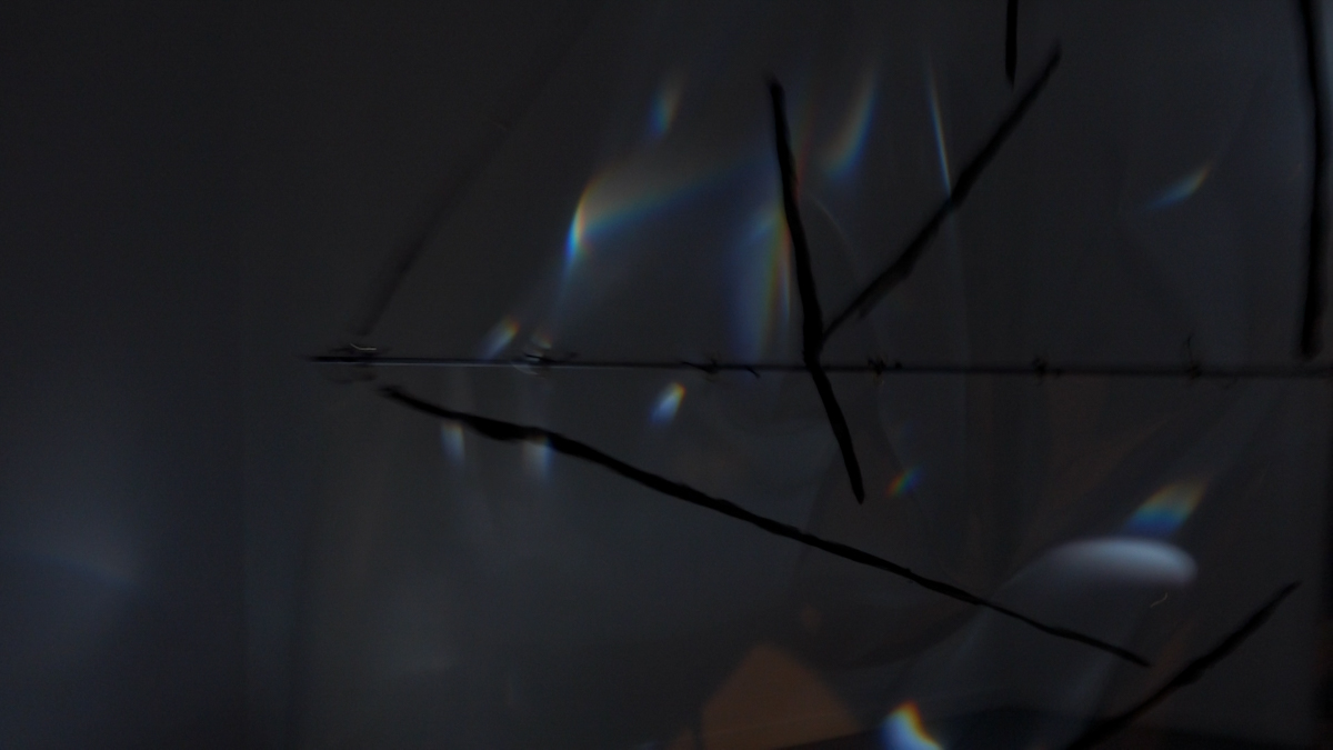 Detail view of refracted spectral light on a translucent foil sail.